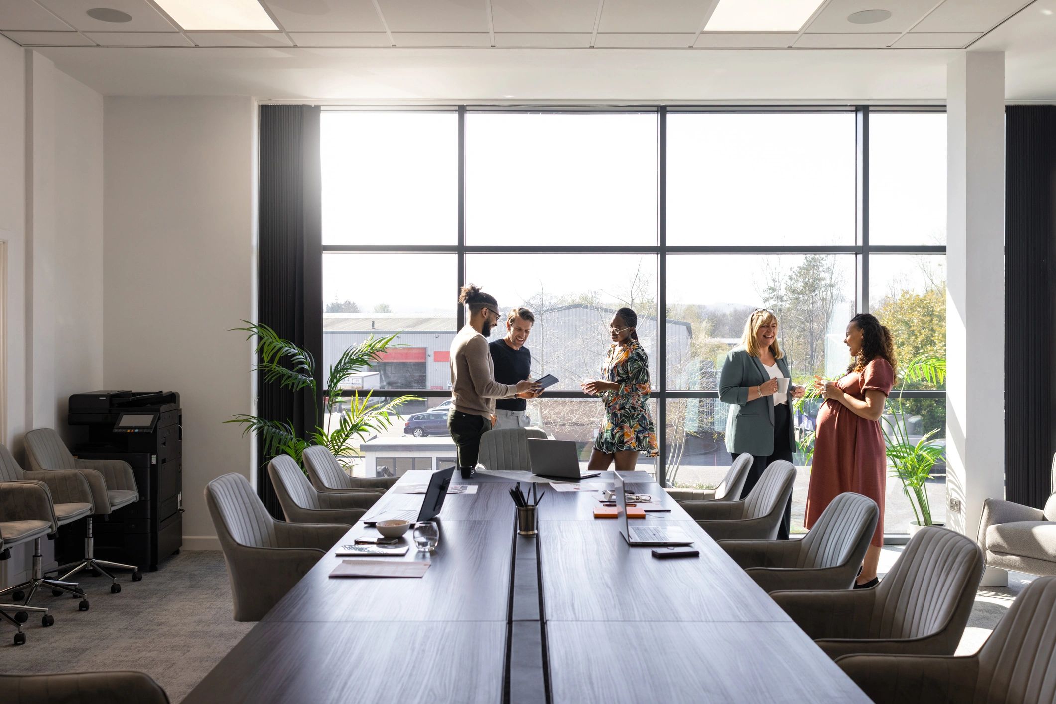 Commercial real estate advisors meeting with clients in a modern office